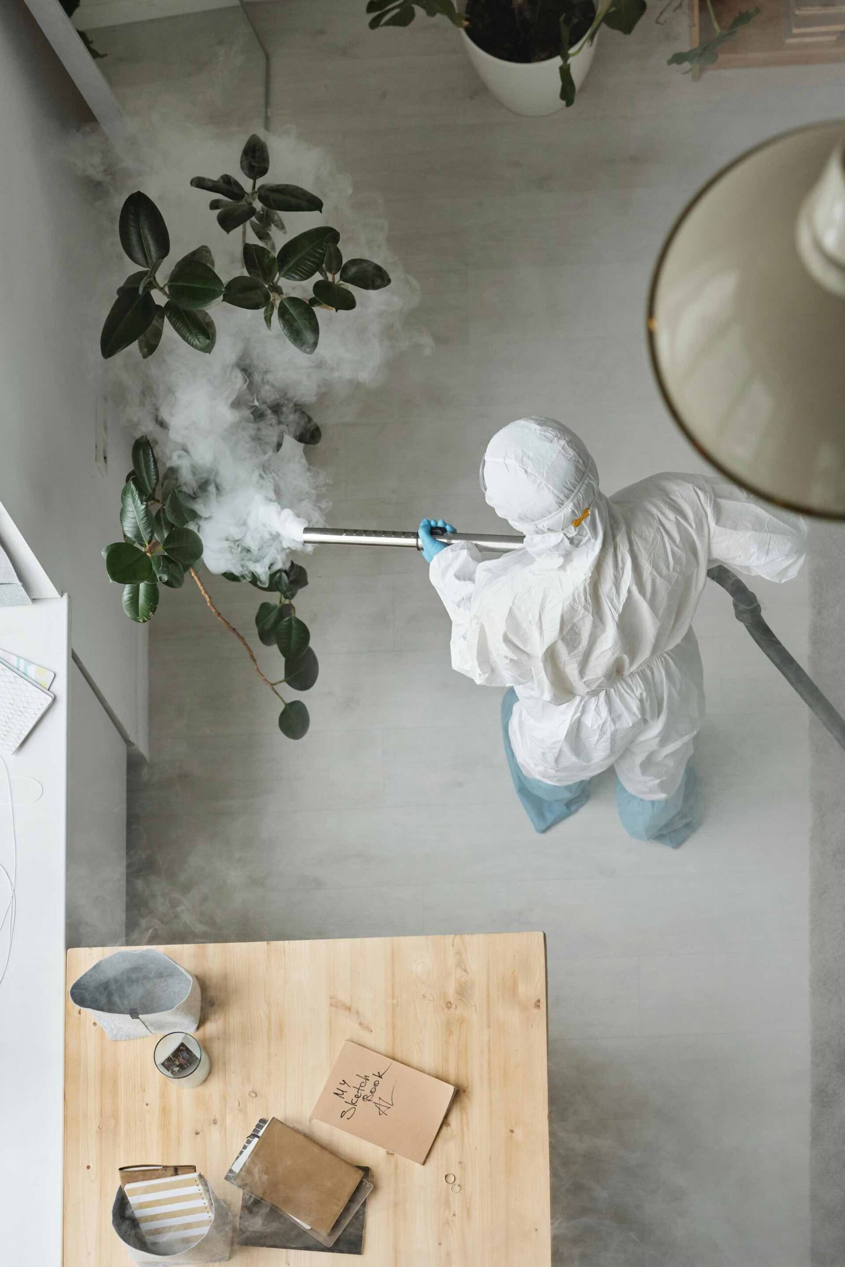 Frost Pest Control exterminators in protective gear, inspecting a property for pest infestations.